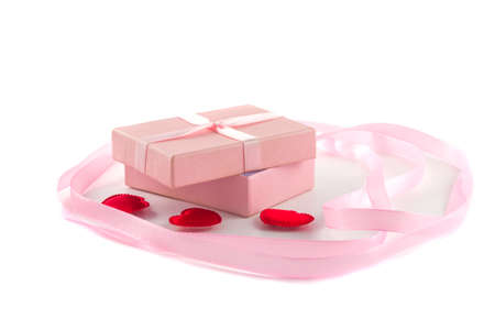 Gift box with a pink ribbon and red hearts and a large pink ribbの写真素材