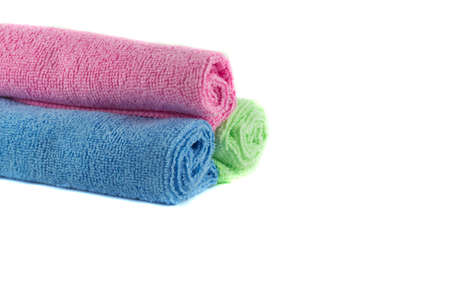 A roll of green, blue and pink towelsの写真素材