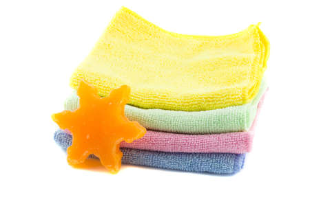 A stack of colorful towels and soap in the shape of a star-shapeの写真素材