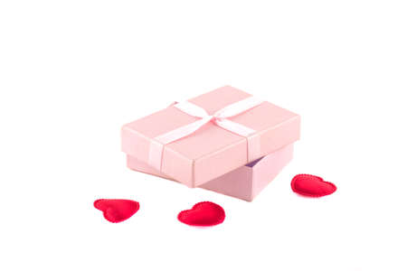Gift box with a pink ribbon and red heartsの写真素材