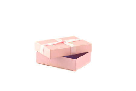 Gift box with a pink ribbon on a white backgroundの写真素材