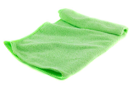 Green towel folded in the shape of a square on a white backgroundの写真素材