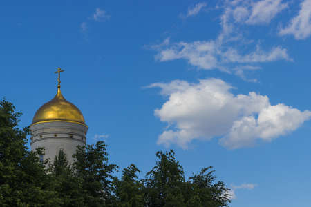 Russian church dome against the blue sky and clouds treesの写真素材