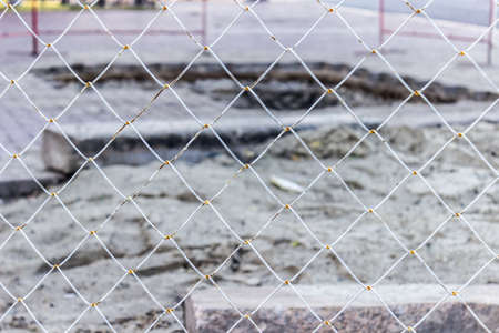 White rusty grate with blurred constructionの写真素材