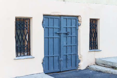 Steel old blue door with windows on the latticeの写真素材