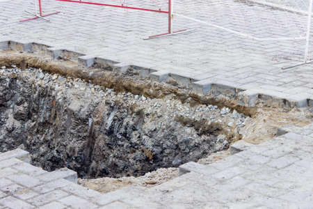 Pit on the road from a stone blocks