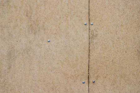 Cardboard sheets are fastened with nails, backgroundの写真素材