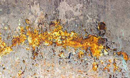 Rusty gray metal wall background with cracks and rustの写真素材