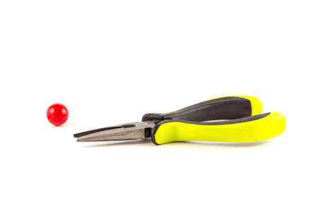 Pliers for beads with red bead on a white backgroundの写真素材