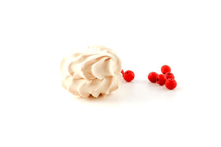 Pink marshmallows and a bunch of red berries on a white backgroundの写真素材