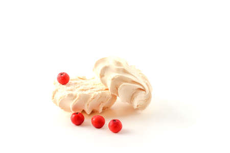 Pink marshmallows and a bunch of red berries on a white backgroundの写真素材