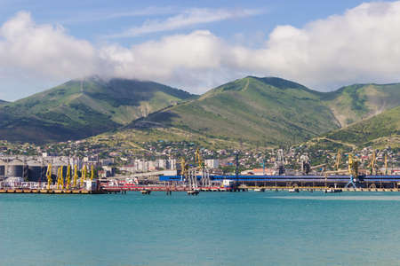 The landscape of the port, on the background of sea and mountainsの写真素材