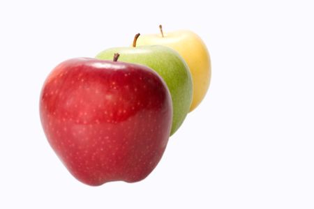 three apples red yellow and green on white background short focusの写真素材