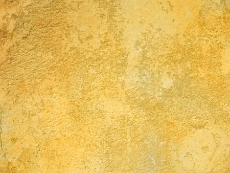 Rough yellow background wall textureの写真素材
