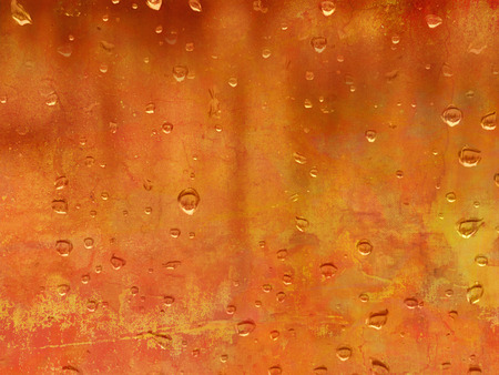 Raindrops against orange background - abstract autumn conceptの写真素材