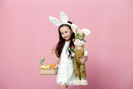 Happy easter! Happy family preparing for Easter. Cute little child girl wearing bunny ears on Easter dayの写真素材