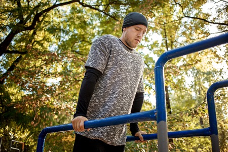 Healthy handsome active man with fit muscular body doing workout exercises.