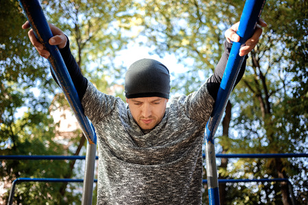 Healthy handsome active man with fit muscular body doing workout exercises. Outdoor, park. Sports...
