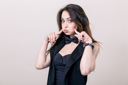 Portrait of a Merry Lady in a business black female costume fooled and crookedの写真素材