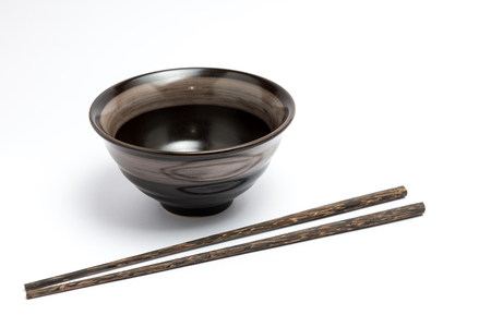 Chopsticks and japanese style bowl isolated on white backgroundの写真素材