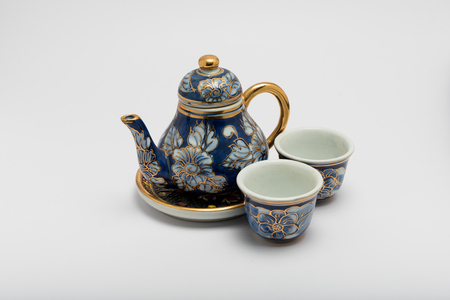ceramic tea pot and cup on white backgroundの写真素材