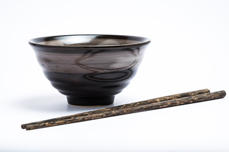 Chopsticks and japanese style bowl isolated on white backgroundの写真素材