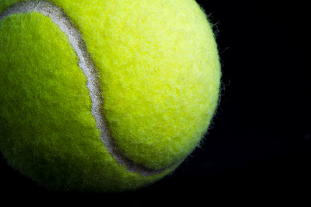 Close up Tennis Ball on black blackground   with dramatic lightingの写真素材