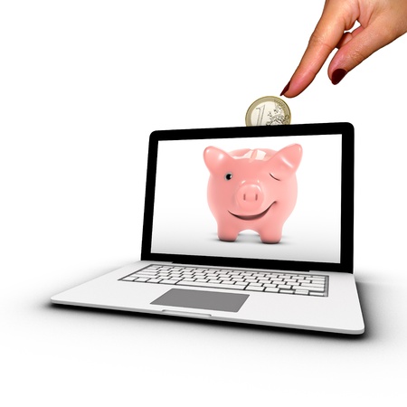 Woman s hand inserting a coin into a laptop  Concept of online bank placement の写真素材