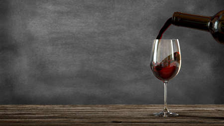Red wine poured from a bottle into a wine glass. Blackboard background. Old wooden table. 3d renderingの写真素材