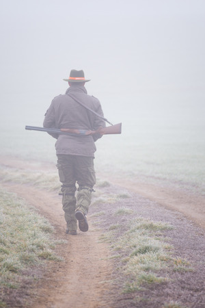 Vertical view of a gamekeeper in autumn fog.の写真素材