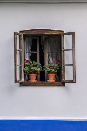 Detail view of old vintage facade with open window. Traditional moravian architecture.の写真素材