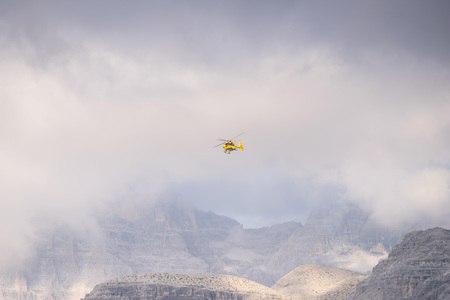 Medical rescue helicopter in air. Italian Dolomites.の写真素材
