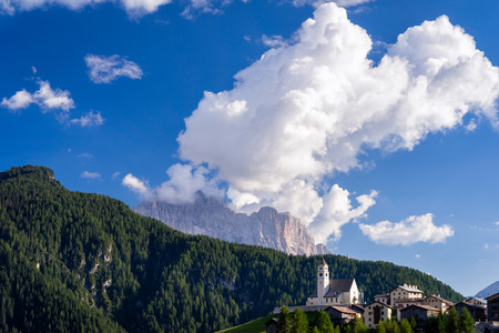 Typical summer scene in Italian Dolomites. Traditional mountain church with majestic mountains in background.の写真素材