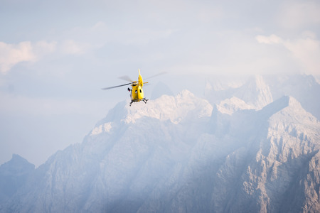 Medical rescue helicopter in air. Italian Dolomites.の写真素材