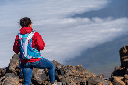 Female hikers enjoying scenic view of Teide National Park, Tenerife, Canary Island. Hiking high...