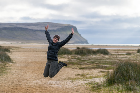 Happy girl on icelandic beach, Westfjords, Iceland.の写真素材
