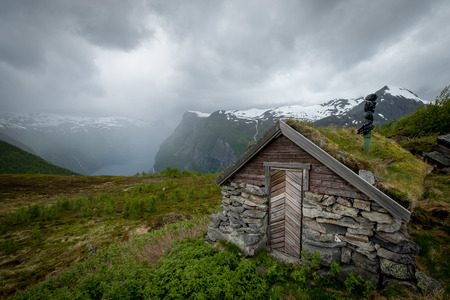 Scenic view of old wooden house with grass on the roof, traditional norway house.の写真素材