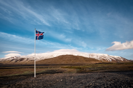 Late evening of typical Icelandic highland landscape with flag of Iceland.の写真素材