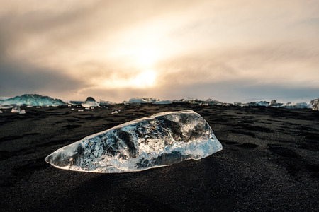Ice on the black volcanic beach near Jokulsarlon glacier lagoon, winter Iceland.の写真素材