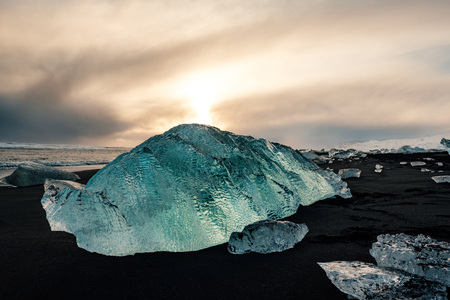 Ice on the black volcanic beach near Jokulsarlon glacier lagoon, winter Iceland.の写真素材