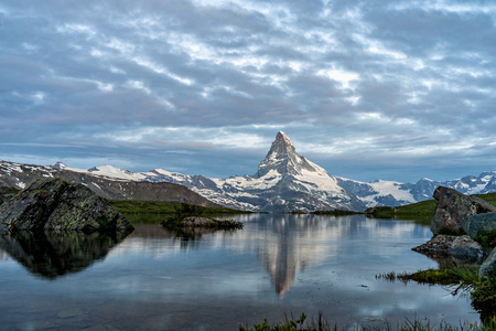 Very early morning shot of the Matterhorn (Monte Cervino, Mont Cervin) pyramid and Stellisee lake....