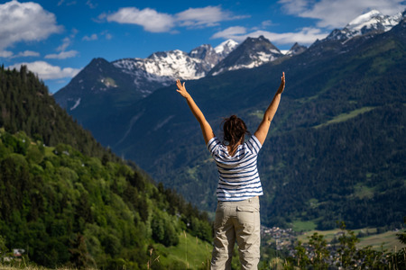 Female traveler admiring views of Swiss Alps in Val de Bagnes area, Switzerland.の写真素材