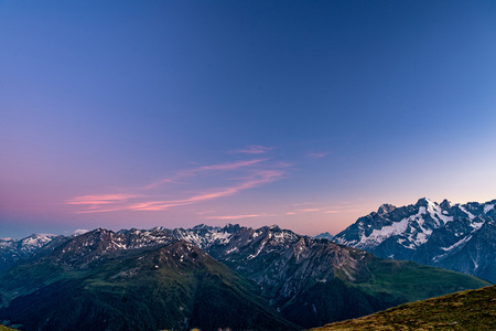 Scenic view of beautiful Swiss Alps mountains. Blue hour sunset with pink and blue tones, Verbier,...