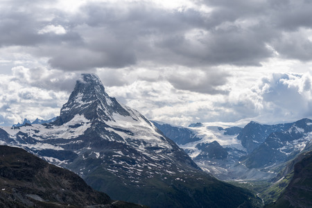 Scenic view of Matterhorn (Monte Cervino, Mont Cervin) mountain peak dramatic overcast with dark heavy clouds, Zermatt, Switzerland.の写真素材