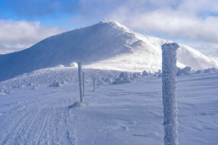 Beautiful winter sunny day on snowy mountains. Snow covered landscape in mountains. Snow trail on mountains.の写真素材