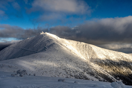 Beautiful winter sunny day on snowy mountains. Snow covered landscape in mountains. Snow trail on mountains.の写真素材