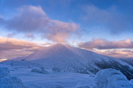 Late evening view of Snezka mountain landscape. Sunset over cold winter mountain landscape.の写真素材