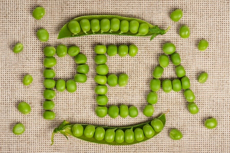 Inscription of fresh green peas on sack closeupの写真素材