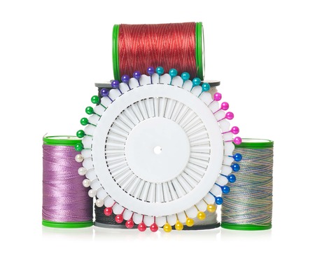 Colorful silk threads with pins isolated on white background