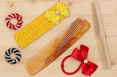 New hairbrush with accessories over wooden surface